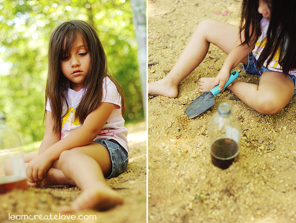 Pushing the dirt up around the bottle of vinegar