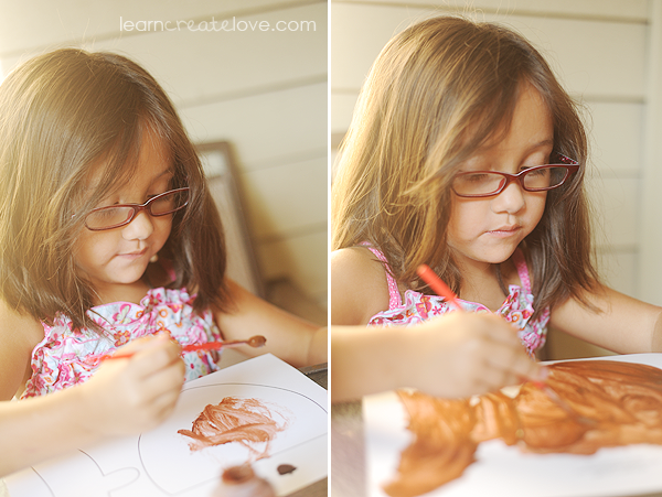 Lorelai painting her acorn craft