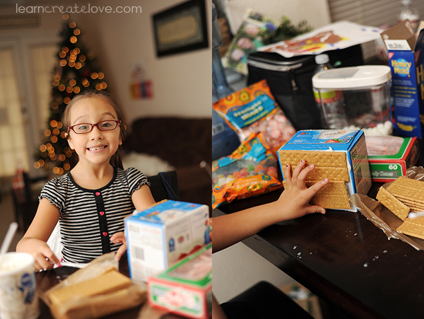 We built a gingerbread house using the end of a yogurt box, graham crackers, frosting, and candy decorations.